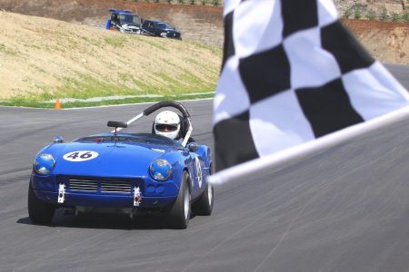The VRCBC's Phil Pidcock accelerates his '65 Triumph Spitfire across the finish line at the Vancouver Island Motorsport Circuit's Grand Opening. - Paul Bonner photo