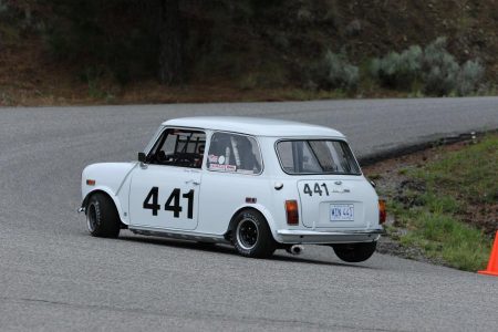 VRCBC member Geoff Tupholme lifts a rear wheel en route to a new personal best and Vintage Class win in his very fast Austin Mini. - Brent Martin photo